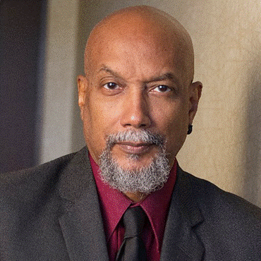 A person in a suit and tie

AI-generated content may be incorrect.